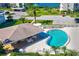 Aerial view of the community pool with shade and lounge chairs at 8211 Brent St # 815, Port Richey, FL 34668