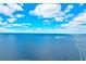 Expansive waterfront view with boats and islands in the distance under a blue sky with light clouds at 8211 Brent St # 815, Port Richey, FL 34668