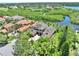 Aerial view of a home, the waterway, and other homes in the community at 8707 Silverthorn Rd, Seminole, FL 33777
