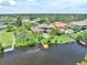Sprawling estate with a private pool, lush landscaping, and a wooden dock on the tranquil waterfront at 8707 Silverthorn Rd, Seminole, FL 33777