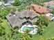 An aerial view showcases a home's expansive backyard with a private pool and lush landscaping at 8707 Silverthorn Rd, Seminole, FL 33777