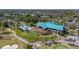 Aerial view of the community clubhouse with a pool, outdoor seating, and golf course access at 8707 Silverthorn Rd, Seminole, FL 33777