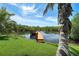 Wooden dock on the water surrounded by lush greenery, offering a serene escape and access to waterfront activities at 8707 Silverthorn Rd, Seminole, FL 33777