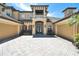 Elegant two-story home with a spacious driveway and a beautiful facade with tan siding and tile roof at 8707 Silverthorn Rd, Seminole, FL 33777