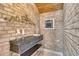 Hallway featuring rustic brick, stylish console table, and a decorative wall hanging, full of character at 8707 Silverthorn Rd, Seminole, FL 33777