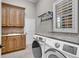 Functional laundry room with ample counter space, cabinetry, and modern washer and dryer at 8707 Silverthorn Rd, Seminole, FL 33777