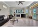 This living room has a fireplace, tile floors, and sliding doors to the pool at 8707 Silverthorn Rd, Seminole, FL 33777