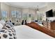 The main bedroom features a large bed, sitting area, and tray ceiling at 8707 Silverthorn Rd, Seminole, FL 33777