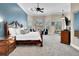 The main bedroom features a large bed, sitting area, and tray ceiling at 8707 Silverthorn Rd, Seminole, FL 33777