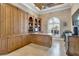 Executive office with custom woodwork and large windows with plantation shutters at 8707 Silverthorn Rd, Seminole, FL 33777