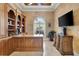 Executive office with custom woodwork and large windows with plantation shutters at 8707 Silverthorn Rd, Seminole, FL 33777