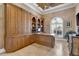 Executive office with custom woodwork and large windows with plantation shutters at 8707 Silverthorn Rd, Seminole, FL 33777