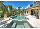 Stunning pool and spa, perfect for relaxation, set in a lush tropical landscape with an outdoor dining area at 8707 Silverthorn Rd, Seminole, FL 33777
