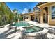 Inviting pool and spa with tile surround, complemented by outdoor lounge area and lush tropical landscaping at 8707 Silverthorn Rd, Seminole, FL 33777