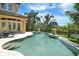 A luxurious private pool with elegant design, surrounded by lush greenery and views of the serene waterway at 8707 Silverthorn Rd, Seminole, FL 33777