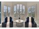 Comfortable sitting area with two chairs and large windows with plantation shutters allowing natural light at 8707 Silverthorn Rd, Seminole, FL 33777