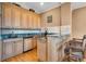 Well-equipped wet bar with custom cabinetry, granite countertops, and bar seating for convenience at 8707 Silverthorn Rd, Seminole, FL 33777