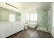 Bright bathroom features a double vanity, a stand alone tub, and a glass shower at 9110 Lantern Oak Way, Land O Lakes, FL 34638