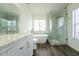 Bright bathroom features a soaking tub, walk-in shower, and vanity with dual sinks at 9110 Lantern Oak Way, Land O Lakes, FL 34638