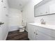 This bathroom is bright and features a tub and shower combo and vanity at 9110 Lantern Oak Way, Land O Lakes, FL 34638