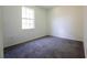 An empty bedroom is painted white and has carpet and natural light at 9110 Lantern Oak Way, Land O Lakes, FL 34638