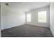 An empty bedroom is painted white and has neutral carpet and natural light at 9110 Lantern Oak Way, Land O Lakes, FL 34638
