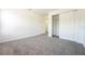 An empty bedroom is painted white with carpet and closet at 9110 Lantern Oak Way, Land O Lakes, FL 34638