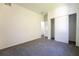 An empty bedroom is painted white with carpet and closet at 9110 Lantern Oak Way, Land O Lakes, FL 34638