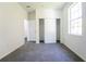 Bright bedroom features a plush carpet, natural light from window, and closet with sliding doors at 9110 Lantern Oak Way, Land O Lakes, FL 34638