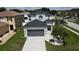 Two story home features a spacious driveway and a gray two car garage door at 9110 Lantern Oak Way, Land O Lakes, FL 34638