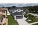 Two story home features a spacious driveway and a gray two car garage door at 9110 Lantern Oak Way, Land O Lakes, FL 34638