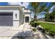 Inviting front yard featuring lush landscaping, decorative stones, and a well-maintained walkway at 9110 Lantern Oak Way, Land O Lakes, FL 34638