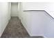 Upstairs hallway featuring neutral carpeting, white walls, white doors, and modern trim at 9110 Lantern Oak Way, Land O Lakes, FL 34638