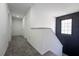 Upper level hallway has a modern design with an accent wall, neutral carpet, and white doors at 9110 Lantern Oak Way, Land O Lakes, FL 34638
