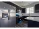 Modern kitchen features stainless steel appliances, dark cabinets, and a bright window at 9110 Lantern Oak Way, Land O Lakes, FL 34638