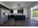 Open kitchen with a central island, modern lighting, and stainless steel refrigerator at 9110 Lantern Oak Way, Land O Lakes, FL 34638