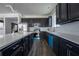 Stylish kitchen features black cabinets, stainless appliances, and a large white countertop at 9110 Lantern Oak Way, Land O Lakes, FL 34638