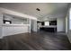 Expansive living space seamlessly connects with the kitchen and features dark wood flooring at 9110 Lantern Oak Way, Land O Lakes, FL 34638