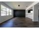 Bright living room with large windows, open layout, and dark hardwood floors at 9110 Lantern Oak Way, Land O Lakes, FL 34638