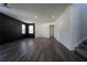 Bright living room with dark vinyl floors, modern lighting, and freshly painted walls at 9110 Lantern Oak Way, Land O Lakes, FL 34638