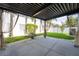 Covered patio with privacy curtains, offering a peaceful outdoor space and garden view at 9110 Lantern Oak Way, Land O Lakes, FL 34638
