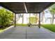 Back patio with concrete floor, pergola with curtains, and landscaped yard at 9110 Lantern Oak Way, Land O Lakes, FL 34638