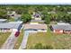 An aerial view of the property shows its front yard, driveway, and a peek at the house's facade at 10831 Manchester Rd, Port Richey, FL 34668