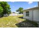 Spacious backyard surrounded by a wood fence under a bright blue sky at 10831 Manchester Rd, Port Richey, FL 34668