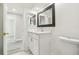 Bathroom featuring a marble vanity, framed mirror, and new hardwood floors at 10831 Manchester Rd, Port Richey, FL 34668