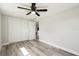 Neutral bedroom featuring wood-look flooring, ample closet space, and access to other rooms at 10831 Manchester Rd, Port Richey, FL 34668