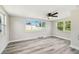 Sun-filled bedroom with light gray floors and bright windows at 10831 Manchester Rd, Port Richey, FL 34668