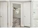 Hallway displaying the entrances to two spacious bedrooms with hardwood flooring at 10831 Manchester Rd, Port Richey, FL 34668