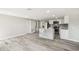 Open-concept kitchen and living room featuring an island with marble countertop and stainless steel appliances at 10831 Manchester Rd, Port Richey, FL 34668