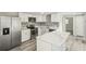 Open kitchen with stainless steel appliances and a marble-style countertop island at 10831 Manchester Rd, Port Richey, FL 34668